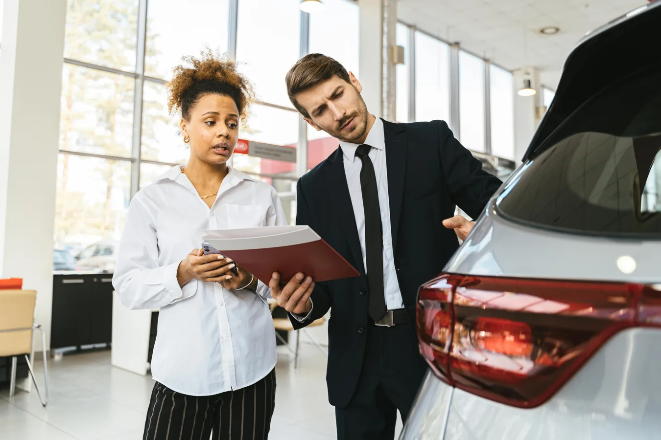 Automotive leaders reviewing dealership operating costs